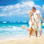 Bride and broom kissing on the beach